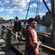 2 men dressed as 18th century sailors on a long ship